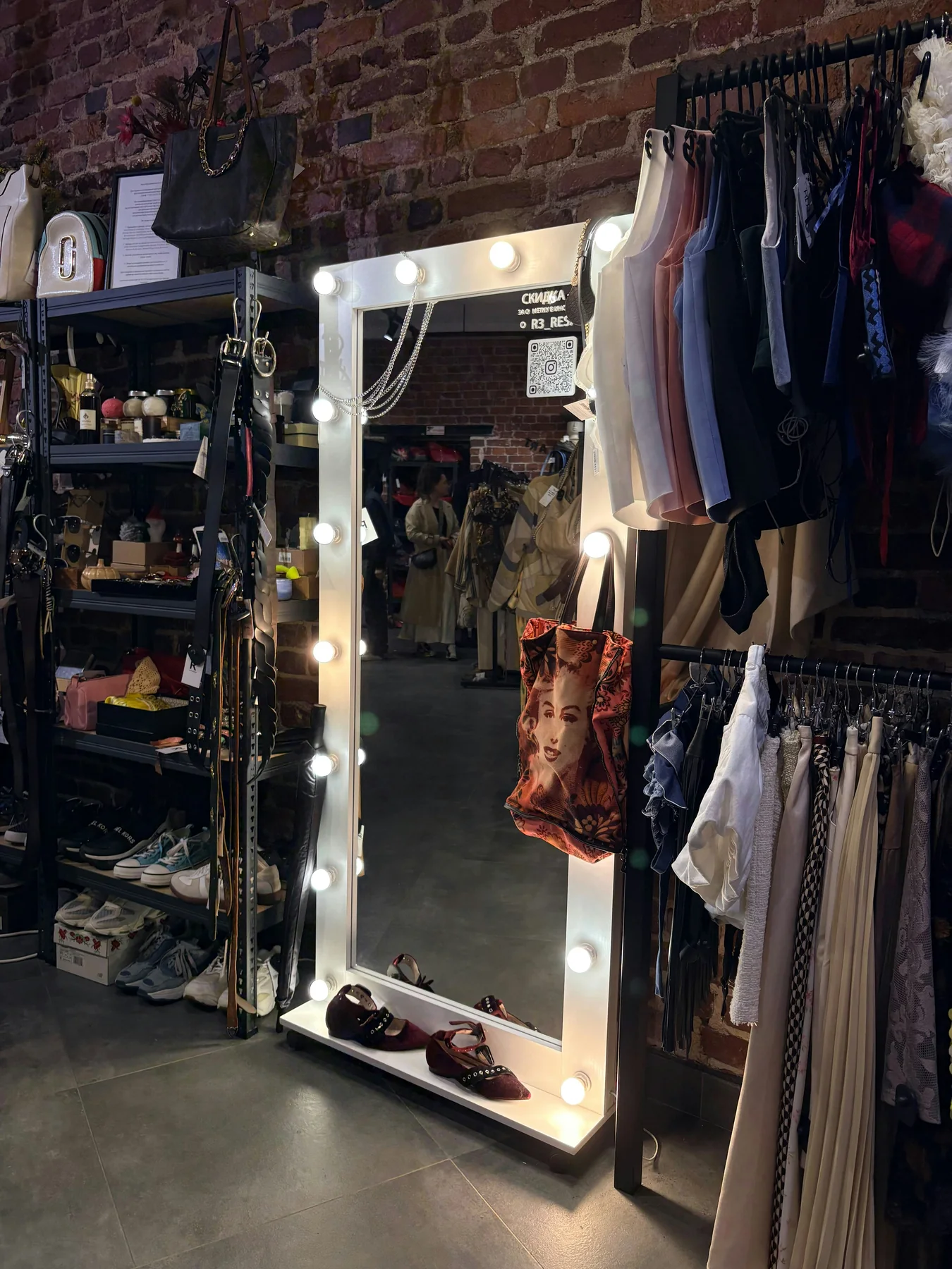 A lit dressing room mirror and wardrobe prepared for a performance